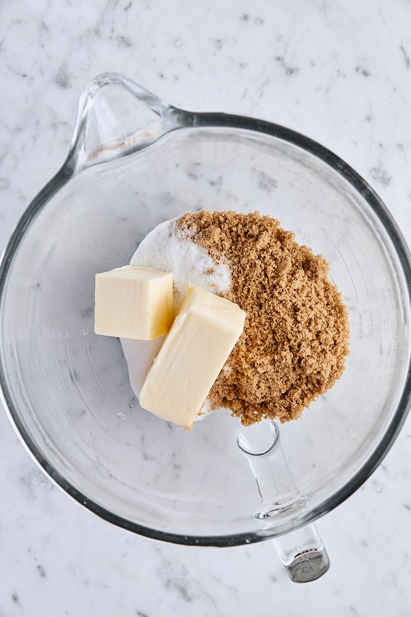 Room temperature butter, light brown sugar, and granulated sugar in glass mixing bowl