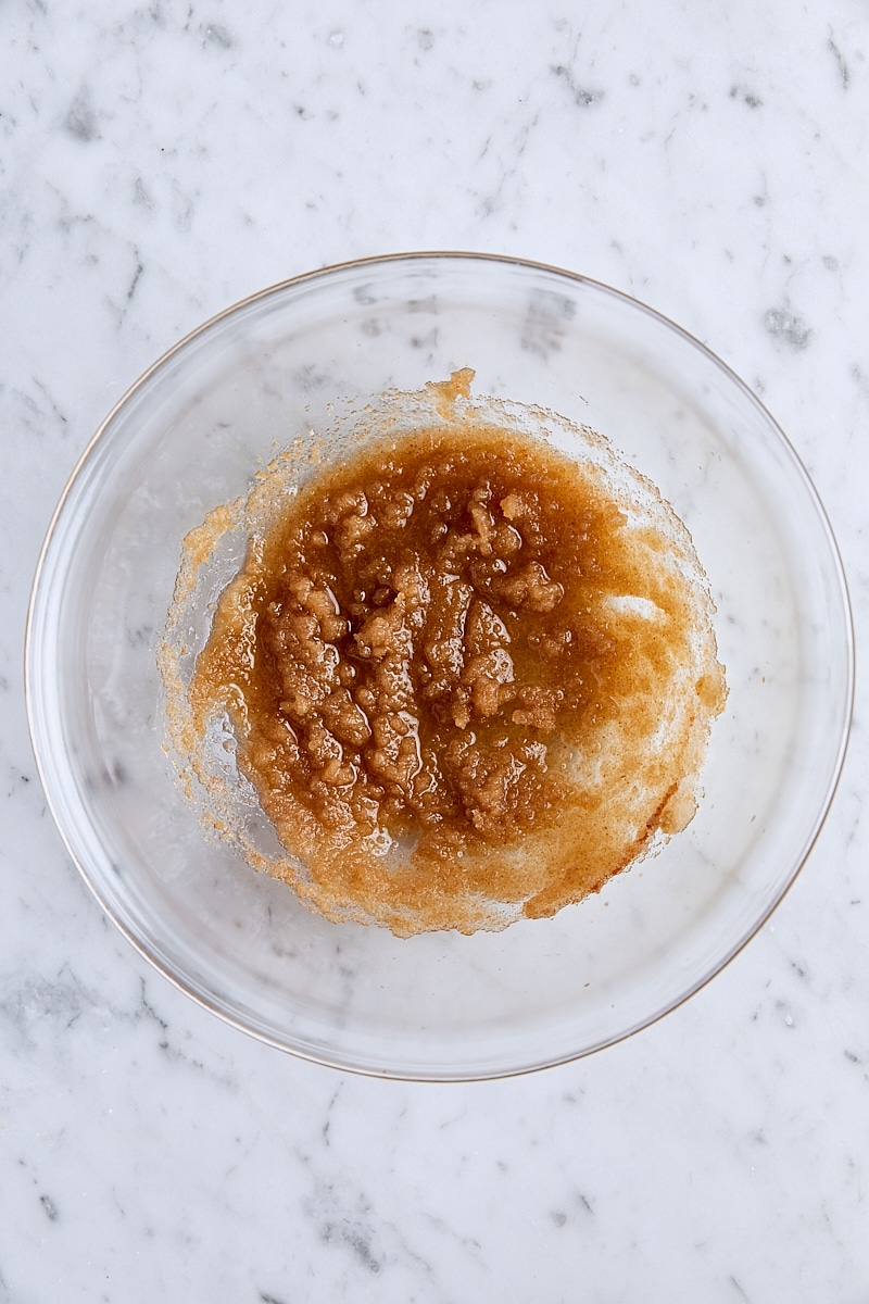 Brown butter and sugars whisked together in glass bowl