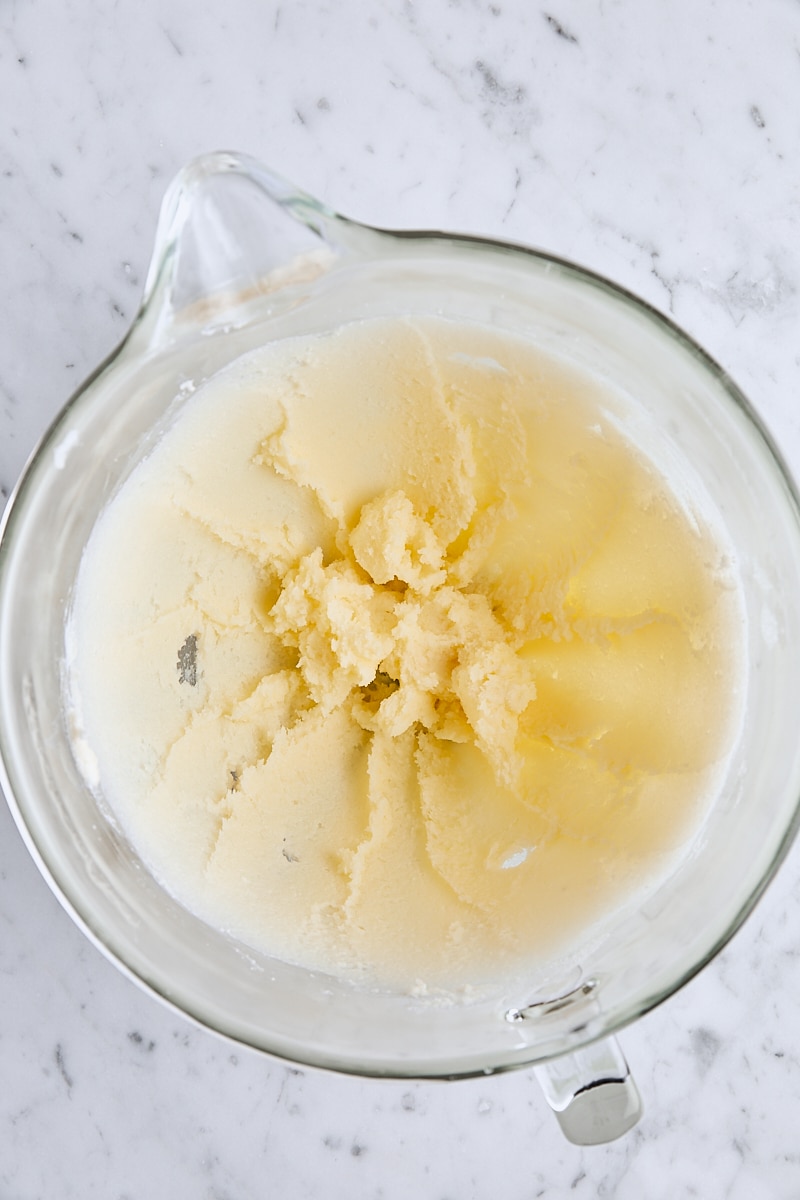 Butter and granulated sugar mixed together in glass mixing bowl