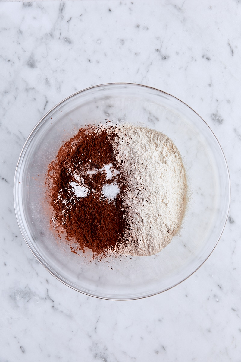 Flour, Dutch process cocoa, baking powder, baking soda, and salt in glass bowl