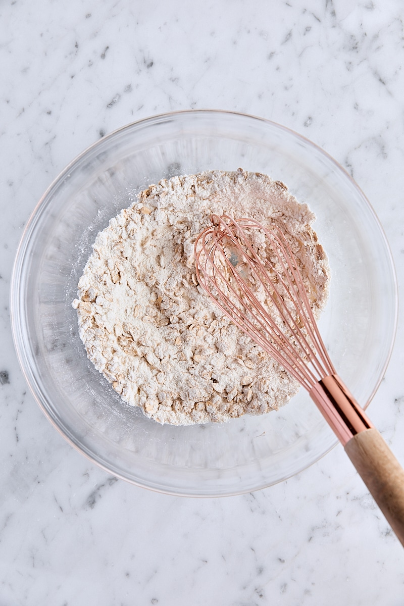 Flour, oats, sugar, and salt whisked together in glass bowl
