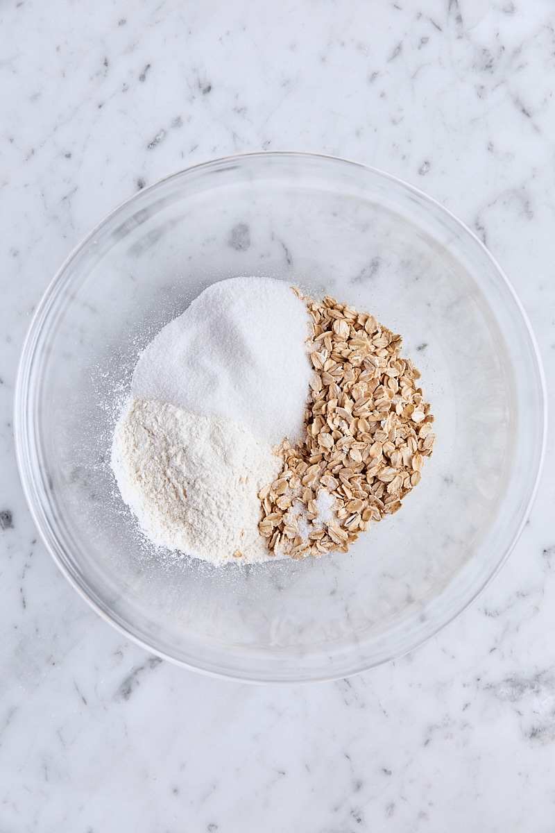 All-purpose flour, rolled oats, granulated sugar, and salt in glass bowl