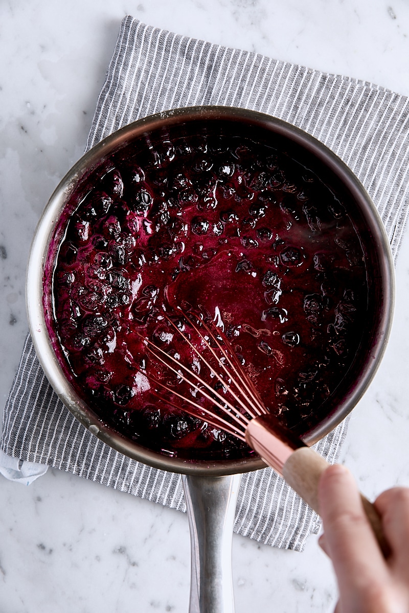 Cornstarch mixture whisked into blueberry filling in saucepan