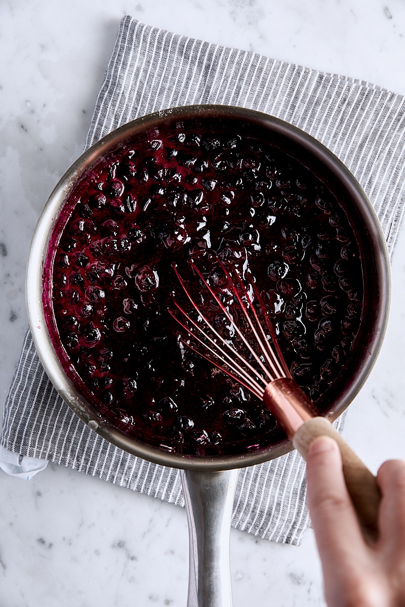 Jammy blueberry pie filling whisked in saucepan