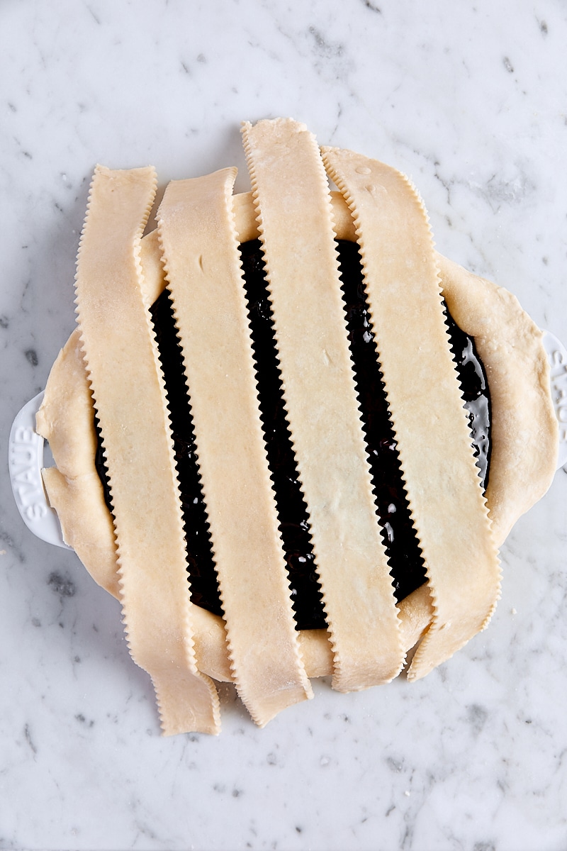 Lattice strips over blueberry pie filling in pie pan