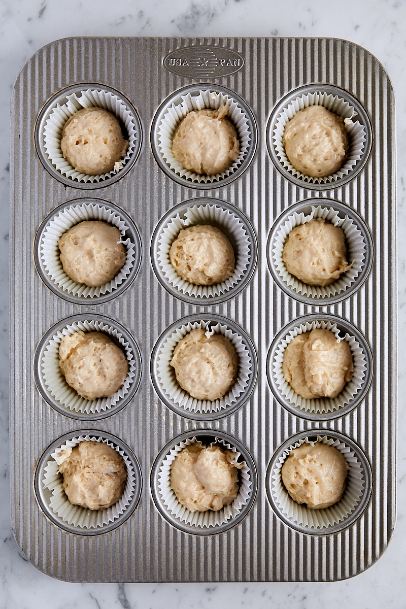 Coffee cake muffin batter scooped into muffin tin