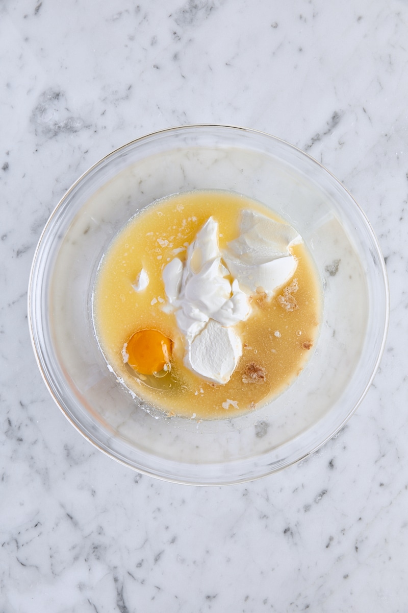 Milk, sour cream, melted butter, egg, and vanilla extract in glass bowl