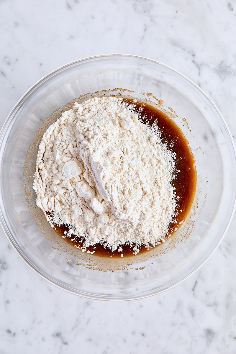 Flour added to blondie batter in glass bowl