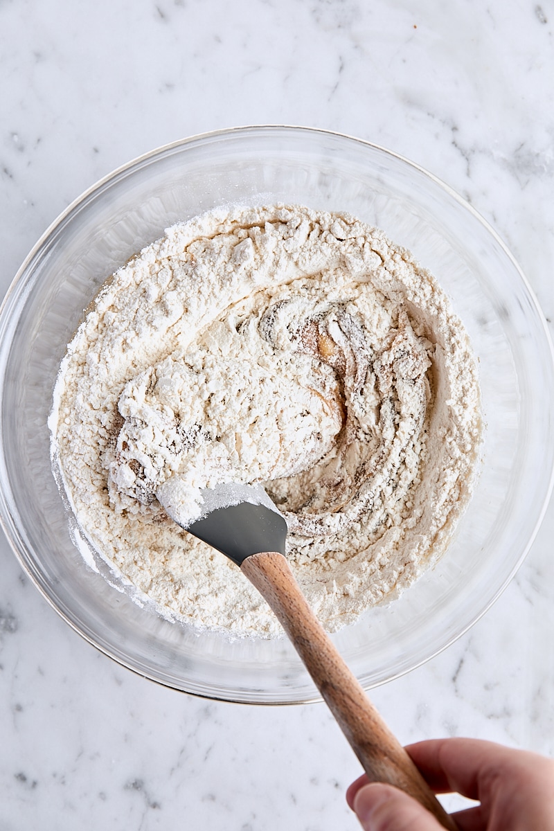 Folding flour into blondie batter with spatula