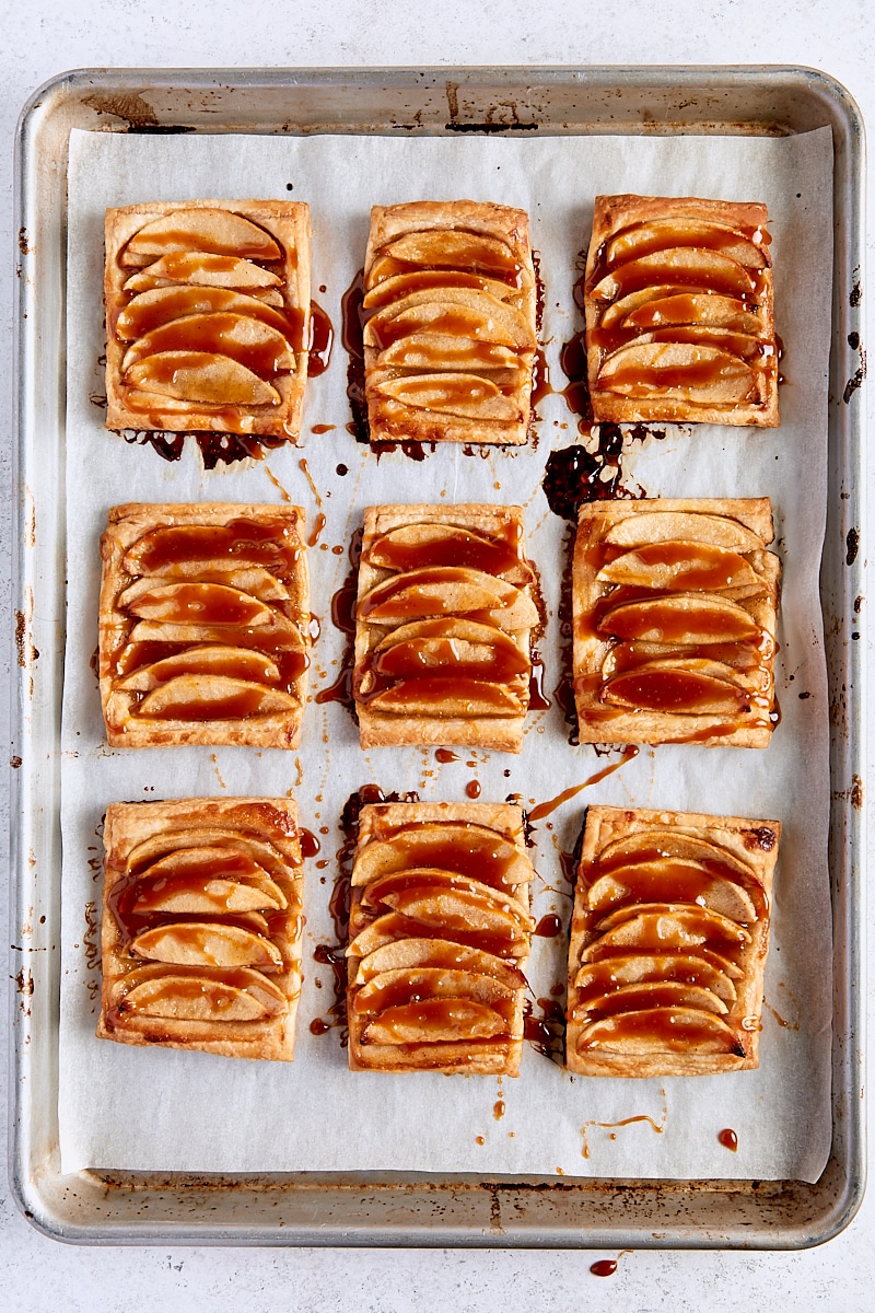 Baked puff pastry apple tarts drizzled with caramel sauce