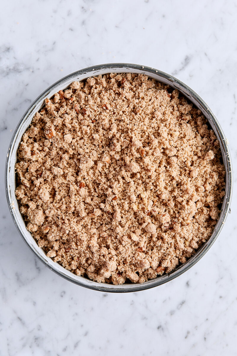 Unbaked streusel-topped coffee cake in springform pan