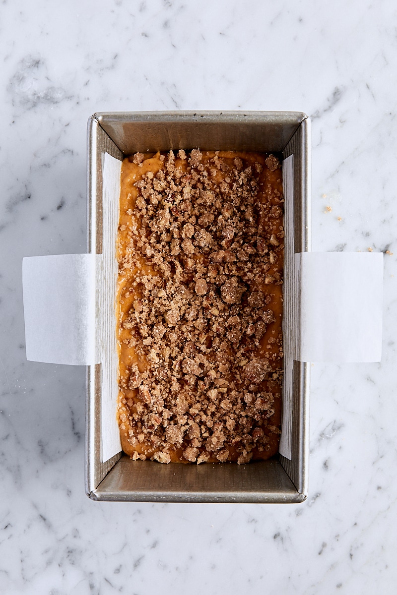 Pumpkin bread batter sprinkled with three tablespoons pecan streusel topping