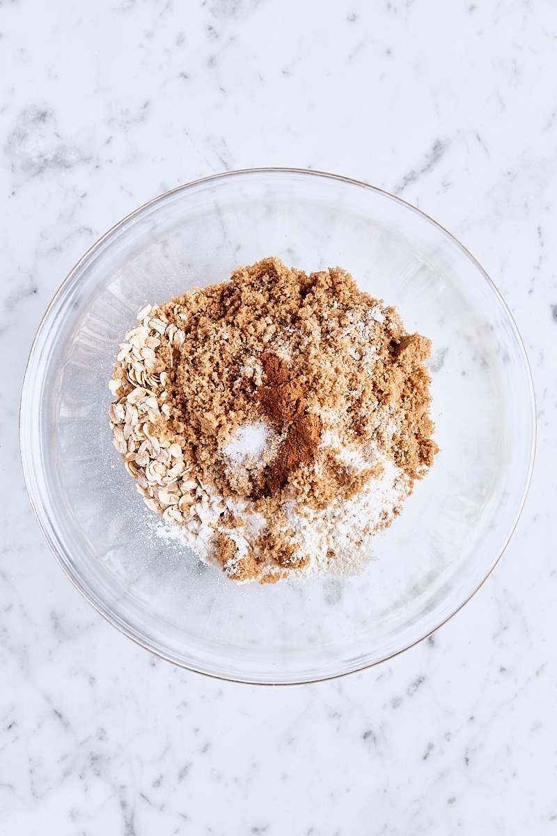 Rolled oats, all-purpose flour, dark brown sugar, cinnamon, and salt in glass bowl