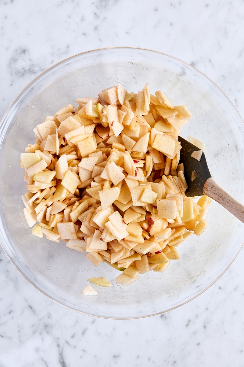 Mixed apple crisp filling in large glass bowl