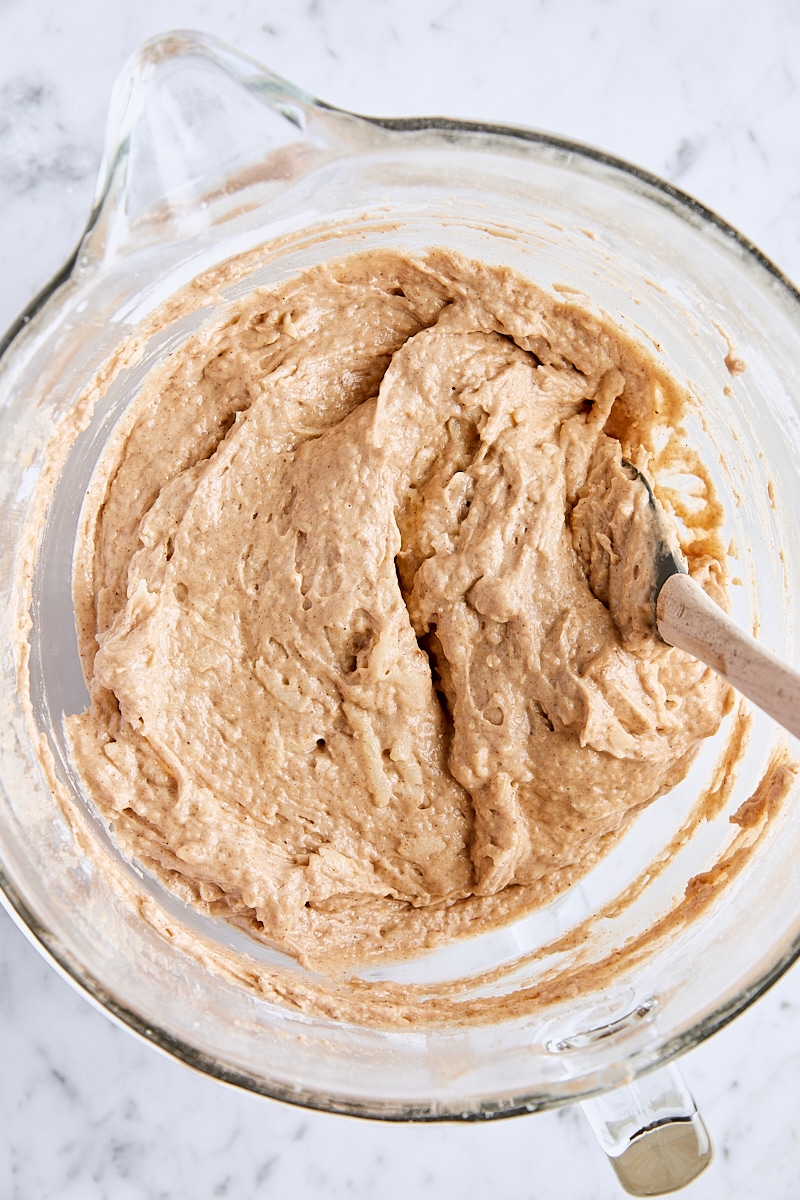 Spice bundt cake batter in glass bowl with spatula