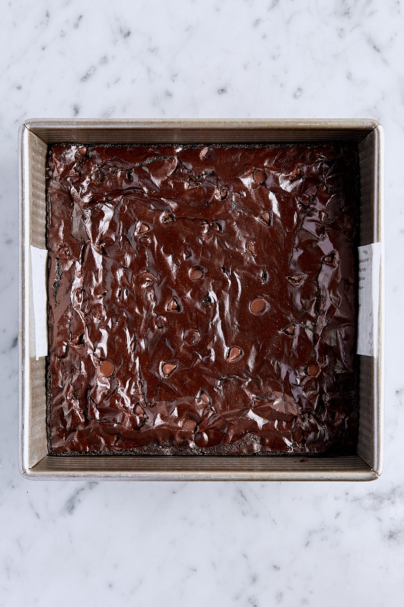Baked cocoa brownies in parchment-lined pan