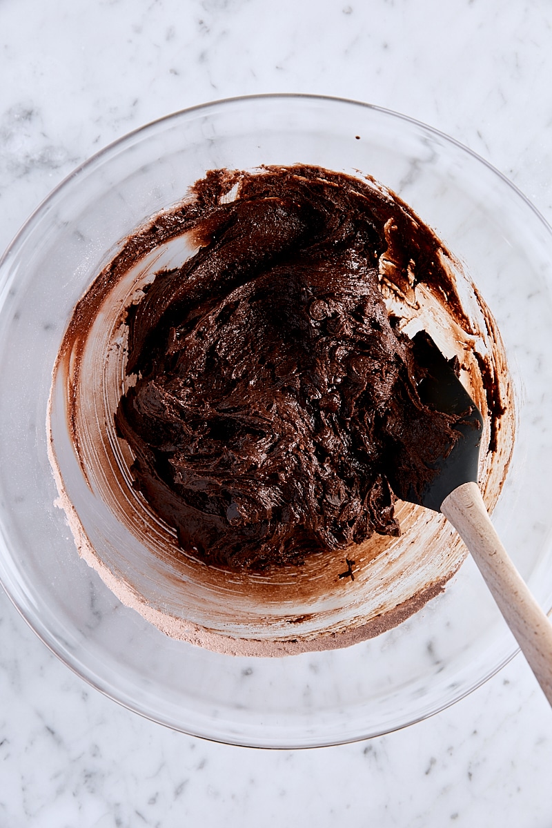 Mixed cookie dough in large bowl with spatula