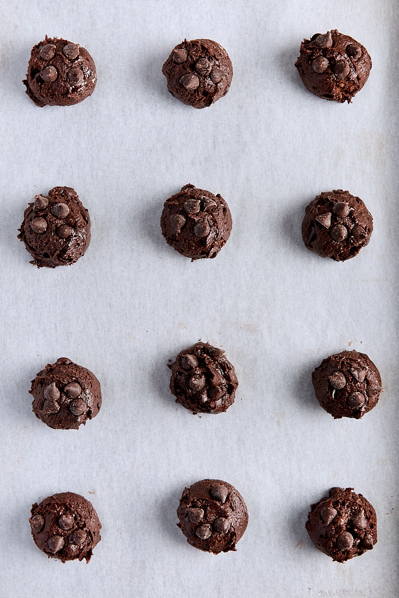 Scooped cookie dough on parchment-lined baking sheet