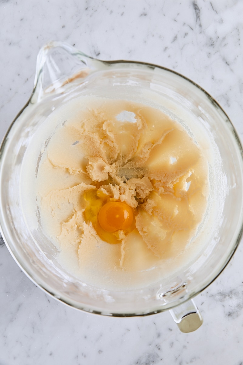 Egg added to batter in glass mixer bowl