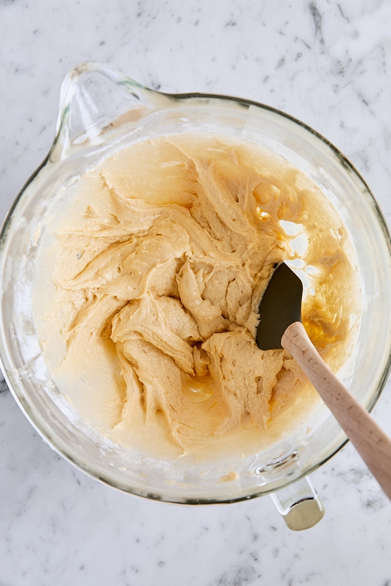 Crumb cake batter in glass mixer bowl with spatula