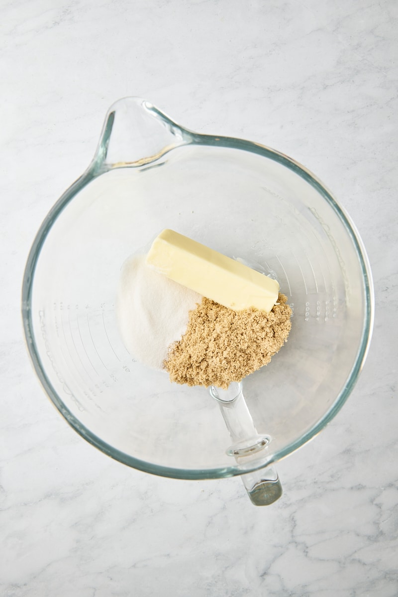 Butter, sugar, and brown sugar in glass mixer bowl