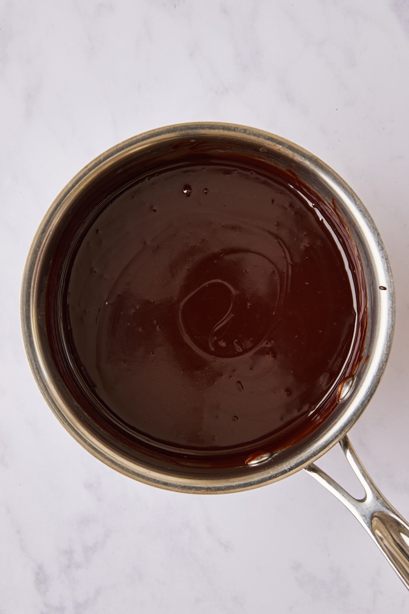 Warm hot fudge in saucepan